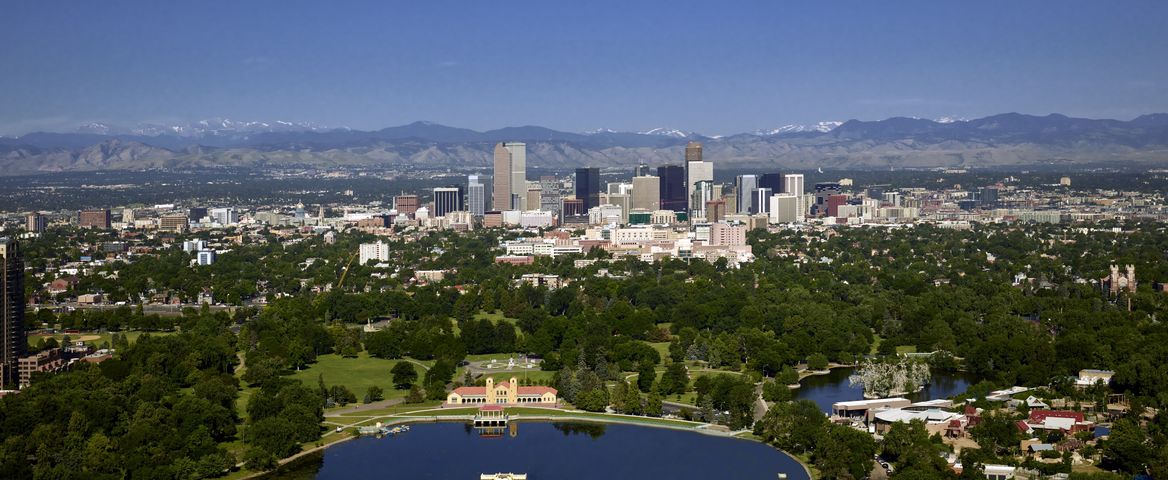 Aerial view of Denver’s City Park with the skyline and mountains beyond